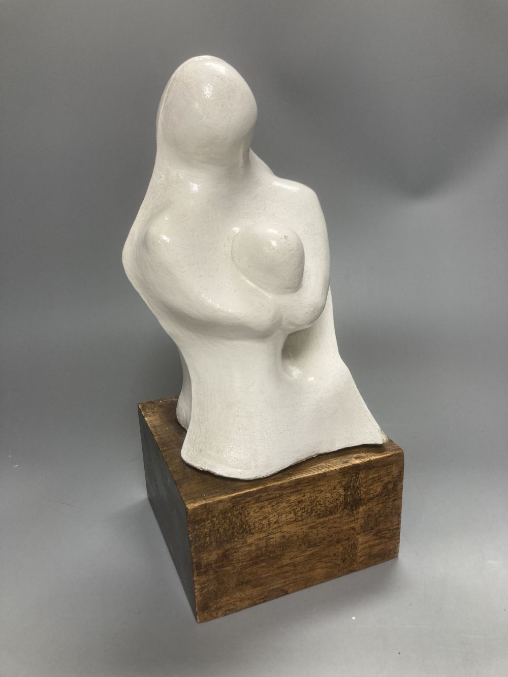 After Henry Moore, two related figural sculptures in wood and plaster, 31cm, white composition, 28cm